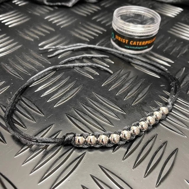 Kaiko Wrist Caterpillar Black on metal background